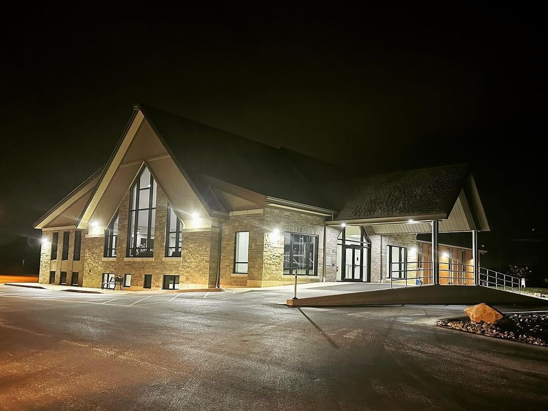 Completed community church with stone and timber detailing at night