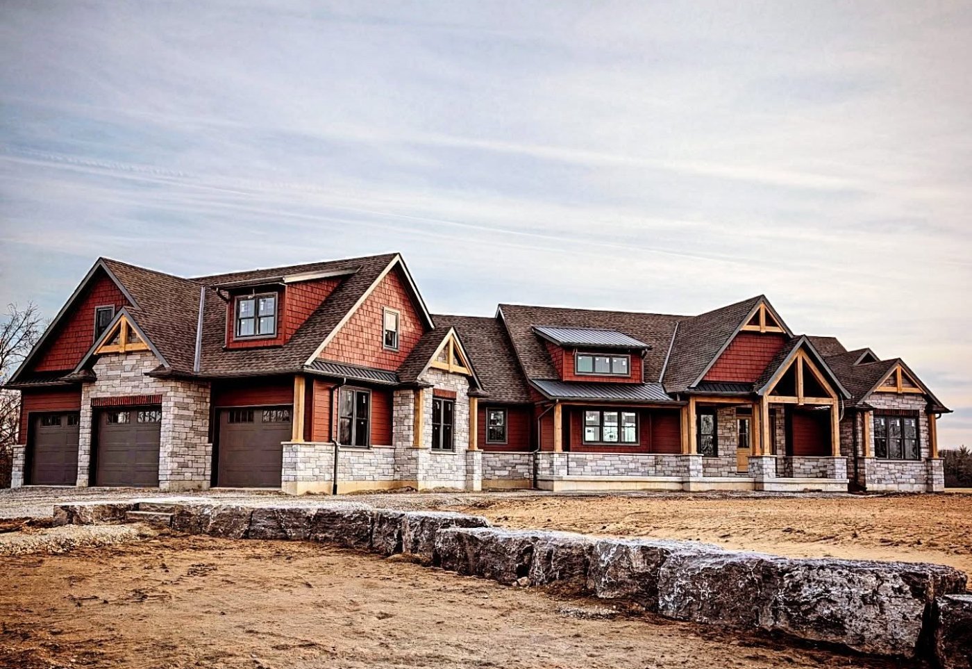 Custom home with stone and timber-accent gables