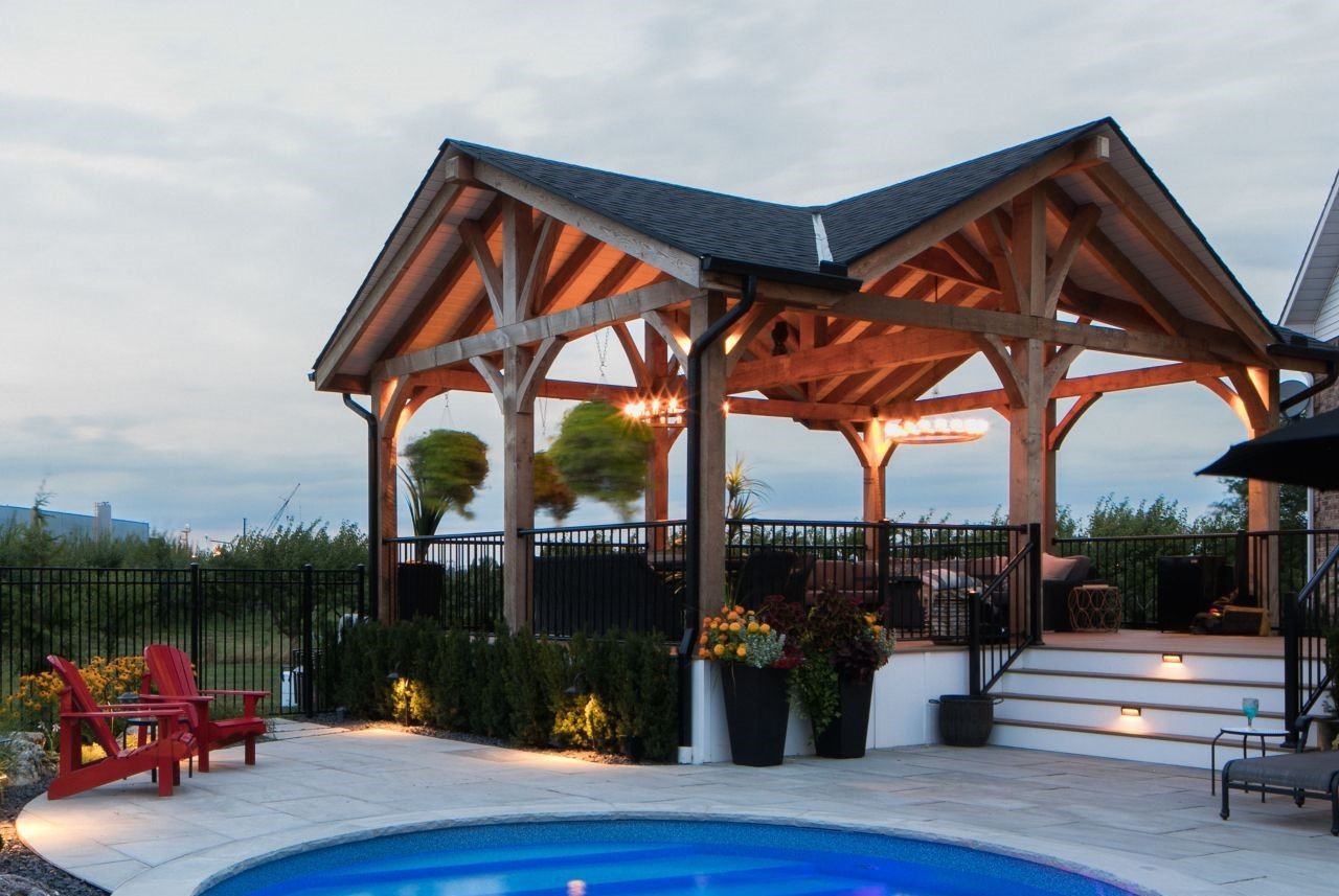 Timber-frame pavilion with engineered Douglas Fir beams over a backyard pool